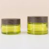 wood print cap green glass cream jar. containers for skincare pr