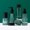 green cylinder thick bottom skincare glass packaging set. cosmet